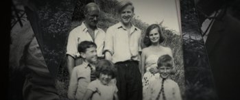 Movie still from “The Pigeon Tunnel” (2023), directed by Errol Morris – An old photo of a family posing for a picture; Medium shot, High angle