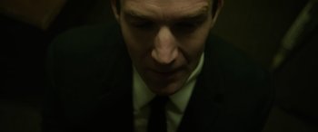Movie still from “The Pigeon Tunnel” (2023), directed by Errol Morris – A person wearing a suit and tie; Extreme Close Up shot, High angle