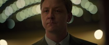 Movie still from “The Pigeon Tunnel” (2023), directed by Errol Morris – A person wearing a suit and tie; Close Up shot, Low angle