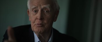 Movie still from “The Pigeon Tunnel” (2023), directed by Errol Morris – An old man with a white beard looking at the camera; Close Up shot, Over the shoulder angle