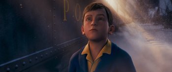 Movie still from “The Polar Express” (2004), directed by Robert Zemeckis – A boy in a blue and yellow shirt is looking up; Close Up shot, High angle