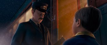 Movie still from “The Polar Express” (2004), directed by Robert Zemeckis – A train conductor talking to a boy in uniform; Medium shot, Over the shoulder angle