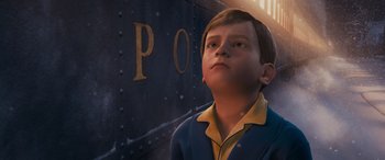 Movie still from “The Polar Express” (2004), directed by Robert Zemeckis – A young boy standing in front of a train car; Close Up shot, High angle