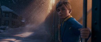 Movie still from “The Polar Express” (2004), directed by Robert Zemeckis – A boy standing next to a train on a train track; Medium shot, Over the shoulder angle