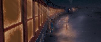 Movie still from “The Polar Express” (2004), directed by Robert Zemeckis – A man standing next to a train on a train track; Extreme Wide shot, High angle