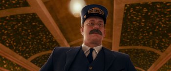 Movie still from “The Polar Express” (2004), directed by Robert Zemeckis – A man in a train conductor's uniform and hat; Close Up shot, Low angle