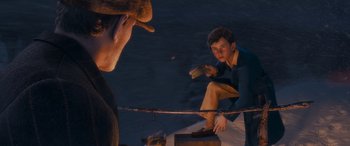 Movie still from “The Polar Express” (2004), directed by Robert Zemeckis – A man sitting on top of a wooden box next to another man; Medium shot, High angle