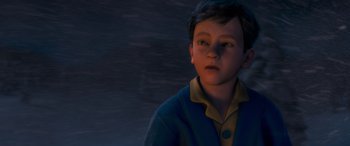 Movie still from “The Polar Express” (2004), directed by Robert Zemeckis – A young boy in a blue and yellow shirt; Close Up shot, High angle