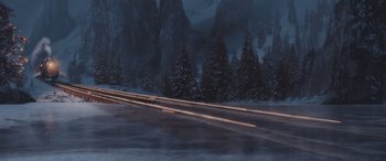 Movie still from “The Polar Express” (2004), directed by Robert Zemeckis – A train traveling down train tracks near a forest; Extreme Wide shot, High angle