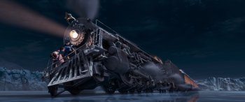 Movie still from “The Polar Express” (2004), directed by Robert Zemeckis – An old steam engine train traveling down the tracks at night; Extreme Wide shot, Low angle