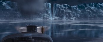 Movie still from “The Polar Express” (2004), directed by Robert Zemeckis – A man sitting on the edge of a body of water; Extreme Wide shot, High angle