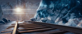 Movie still from “The Polar Express” (2004), directed by Robert Zemeckis – A view of a body of water with a mountain in the background; Extreme Wide shot, High angle