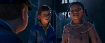 Movie still from “The Polar Express” (2004), directed by Robert Zemeckis – Two children standing next to each other in front of a building; Medium shot, High angle