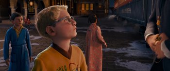 Movie still from “The Polar Express” (2004), directed by Robert Zemeckis – A boy and a girl standing in front of a building; Medium shot, Over the shoulder angle