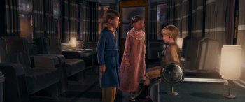 Movie still from “The Polar Express” (2004), directed by Robert Zemeckis – Three children are standing in a living room together; Medium shot, High angle