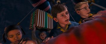 Movie still from “The Polar Express” (2004), directed by Robert Zemeckis – A boy is holding a gift box while another boy is holding an apple; Close Up shot, Over the shoulder angle