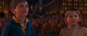 Movie still from “The Polar Express” (2004), directed by Robert Zemeckis – A crowd of people standing next to each other in front of a train at night; Medium shot, High angle
