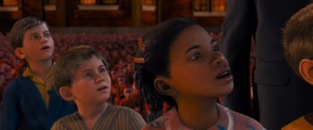 Movie still from “The Polar Express” (2004), directed by Robert Zemeckis – Two young children are standing in front of a crowd; Close Up shot, Low angle