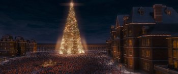 Movie still from “The Polar Express” (2004), directed by Robert Zemeckis – A crowd of people standing around a large christmas tree; Extreme Wide shot, Low angle