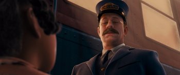 Movie still from “The Polar Express” (2004), directed by Robert Zemeckis – A man in a train conductor's hat and tie; Close Up shot, Over the shoulder angle