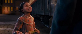 Movie still from “The Polar Express” (2004), directed by Robert Zemeckis – A little girl holding a piece of paper in front of a train; Medium shot, Over the shoulder angle
