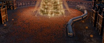 Movie still from “The Polar Express” (2004), directed by Robert Zemeckis – An aerial view of a crowd of people in front of a fountain; Extreme Wide shot, High angle