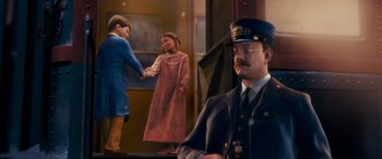 Movie still from “The Polar Express” (2004), directed by Robert Zemeckis – A man in a uniform and a woman in a dress shaking hands; Medium shot, Over the shoulder angle