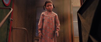 Movie still from “The Polar Express” (2004), directed by Robert Zemeckis – A young girl in a pink nightgown standing in front of a door; Medium shot, High angle