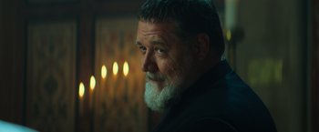 Movie still from “The Pope's Exorcist” (2023), directed by Julius Avery – A person with a beard; Close Up shot, Over the shoulder angle