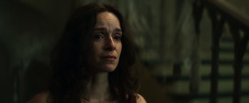 Movie still from “The Pope's Exorcist” (2023), directed by Julius Avery – A person with long hair; Close Up shot, Low angle