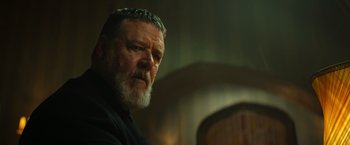 Movie still from “The Pope's Exorcist” (2023), directed by Julius Avery – An older man with a beard is looking at the camera; Close Up shot, Low angle