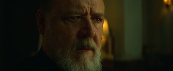 Movie still from “The Pope's Exorcist” (2023), directed by Julius Avery – An old man with a beard and a goatee looking at the camera; Close Up shot, Low angle