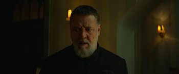 Movie still from “The Pope's Exorcist” (2023), directed by Julius Avery – An older man with a beard and a mustache; Close Up shot, Over the shoulder angle