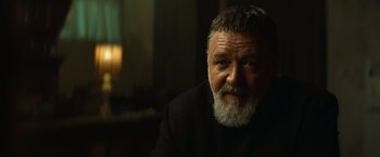 Movie still from “The Pope's Exorcist” (2023), directed by Julius Avery – An older man with a beard and a mustache; Close Up shot, Over the shoulder angle
