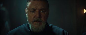 Movie still from “The Pope's Exorcist” (2023), directed by Julius Avery – An older man with a beard is looking at the camera; Close Up shot, Low angle