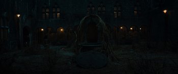 Movie still from “The Pope's Exorcist” (2023), directed by Julius Avery – An empty room with a round table in front of a building; Extreme Wide shot, High angle