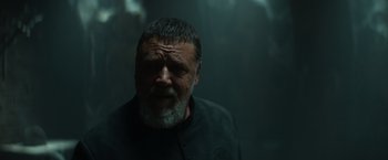 Movie still from “The Pope's Exorcist” (2023), directed by Julius Avery – An old man with a beard is looking at the camera; Close Up shot, Low angle