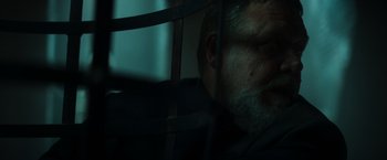 Movie still from “The Pope's Exorcist” (2023), directed by Julius Avery – A person's face behind bars; Close Up shot, Low angle