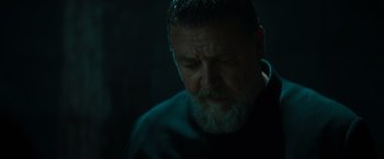 Movie still from “The Pope's Exorcist” (2023), directed by Julius Avery – A person with a beard; Close Up shot, Low angle