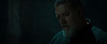 Movie still from “The Pope's Exorcist” (2023), directed by Julius Avery – An older man with a beard is looking at the camera; Close Up shot, Low angle