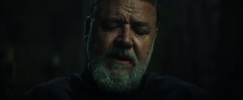 Movie still from “The Pope's Exorcist” (2023), directed by Julius Avery – An old man with a beard and a mustache is looking down; Close Up shot, Low angle