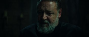 Movie still from “The Pope's Exorcist” (2023), directed by Julius Avery – A person with a beard; Close Up shot, Low angle