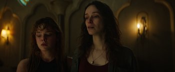 Movie still from “The Pope's Exorcist” (2023), directed by Julius Avery – A woman standing next to another woman in front of a wall; Close Up shot, Low angle