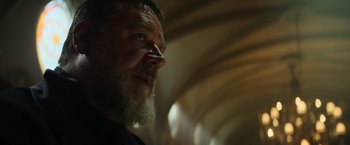Movie still from “The Pope's Exorcist” (2023), directed by Julius Avery – An older man with a beard looking up at the ceiling; Close Up shot, Low angle