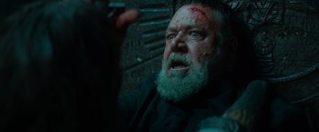 Movie still from “The Pope's Exorcist” (2023), directed by Julius Avery – A man with a beard and a bloody face; Close Up shot, Low angle