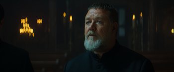 Movie still from “The Pope's Exorcist” (2023), directed by Julius Avery – A man with a gray beard looking up at the ceiling; Close Up shot, Low angle