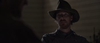 Movie still from “The Power of the Dog” (2021), directed by Jane Campion – A man wearing a hat and looking into the distance; Close Up shot, Over the shoulder angle