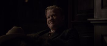 Movie still from “The Power of the Dog” (2021), directed by Jane Campion – A person wearing a suit and tie; Close Up shot, Over the shoulder angle