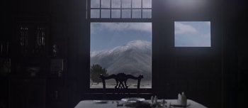 Movie still from “The Power of the Dog” (2021), directed by Jane Campion – A view of a snowy mountain from a window; Extreme Wide shot, Low angle
