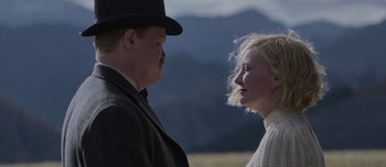 Movie still from “The Power of the Dog” (2021), directed by Jane Campion – A man and a woman standing next to each other in a field; Close Up shot, Over the shoulder angle